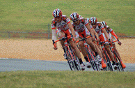 Image of a bicycle race team in red full visible